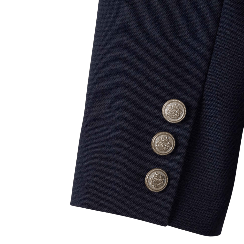 Navy blue blazer sleeve with three decorative silver buttons.